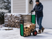 Winter firewood cart scene with person pushing cart